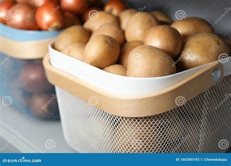 Baskets with Potatoes and Onions on Shelf. Orderly Storage Stock Image ...