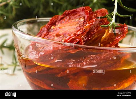 Sun dried tomatoes with olive oil Stock Photo - Alamy