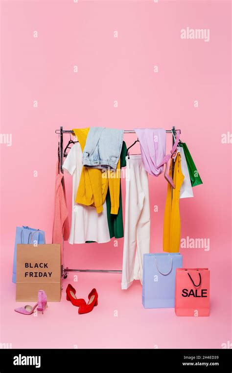 assortment of clothes near footwear and shopping bags with black friday ...