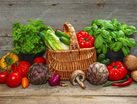 Fresh vegetables and herbs on wooden background Stock Photo by ...
