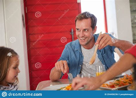 Good Food, Good Mood. a Happy Family Enjoying a Home-cooked Meal ...