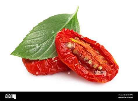Dried or Sundried tomato halves with thai basil isolated Stock Photo ...