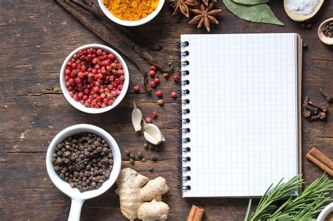 Premium Photo | Open recipe book with fresh herbs and spices on wooden ...