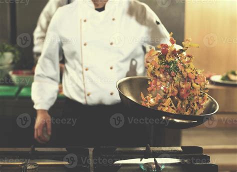 chef flipping vegetables in wok 10781155 Stock Photo at Vecteezy