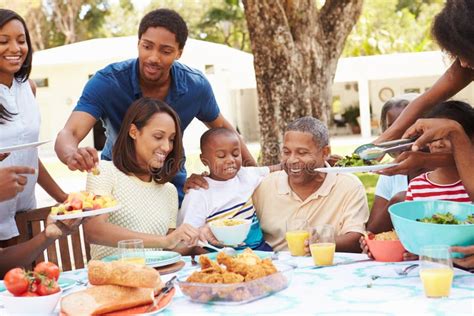Multi Generation Family Enjoying Meal in Garden Together Stock Image ...