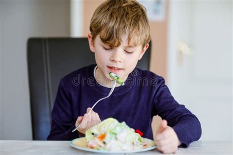 Happy Kid Boy Eating Fresh Salad with Tomato, Cucumber and Different ...