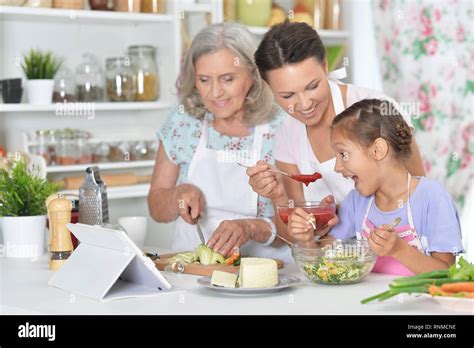 Portrait of smiling happy family cooking together Stock Photo - Alamy