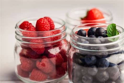 Premium Photo | Glass jars of fresh berries