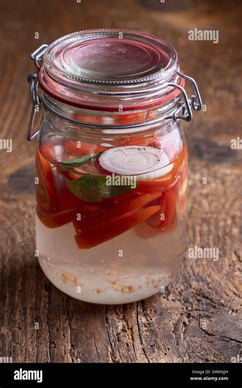 Fermenting tomatoes in a jar on wood Stock Photo - Alamy