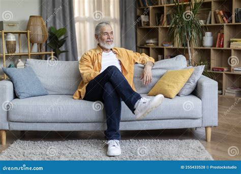 Relaxed Elderly Man Chilling on Couch at Home Stock Photo - Image of ...