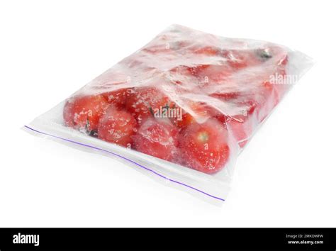 Frozen tomatoes in plastic bag isolated on white. Vegetable ...