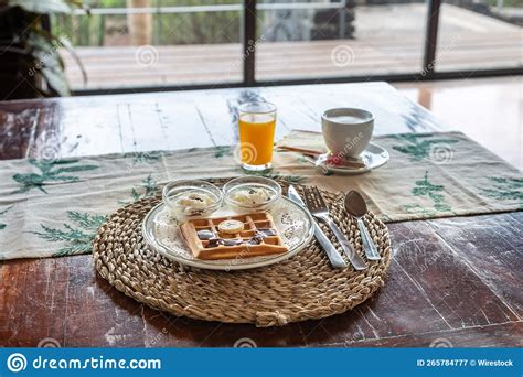 Cozy Rustic Breakfast in the Cafe on Wooden Table with Waffles, Juice ...