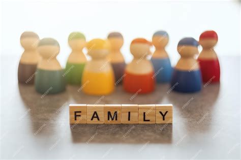 Premium Photo | Family word on wooden blocks with a group of people in ...