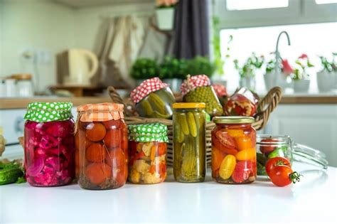 Premium Photo | Jars with preserved vegetables for the winter selective ...