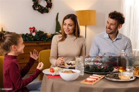 Happy Family Enjoying A Festive Christmas Dinner Together At Home High ...