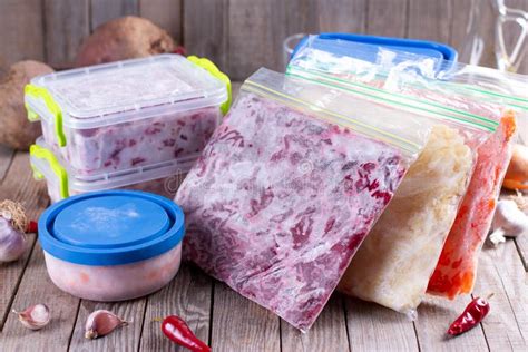 Frozen Food in Containers and Bags on the Table. Frozen Vegetables ...