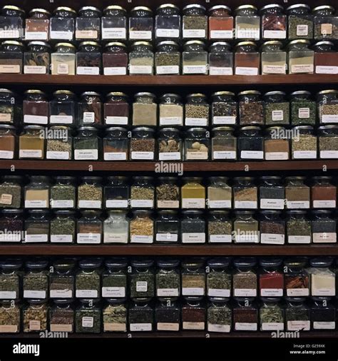 Jars of dried herbs on shelves Stock Photo - Alamy