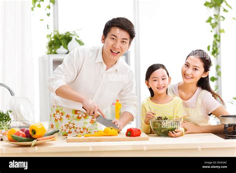 Family preparing food in kitchen Stock Photo - Alamy