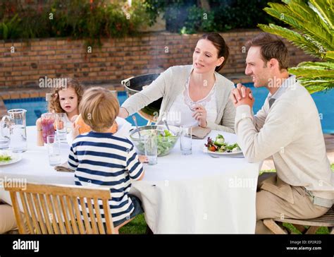 Family eating in the garden Stock Photo - Alamy
