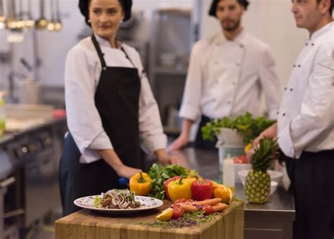 Premium Photo | Professional team cooks and chefs preparing meal at ...