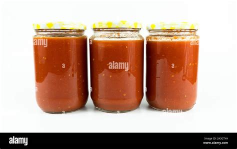 Tomato sauce in a jar. Homemade tomato sauce making process concept ...