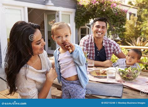 Portrait of Family at Home Eating Outdoor Meal in Garden Stock Photo ...