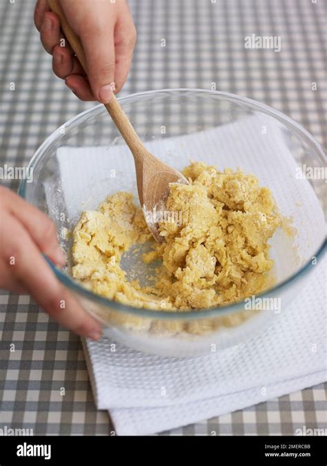 Making basic cookie or biscuit dough, mixing in flour with spoon Stock ...