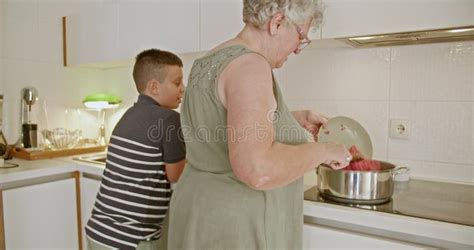 Grandmother Teaches Grandson To Cook Stock Footage - Video of female ...
