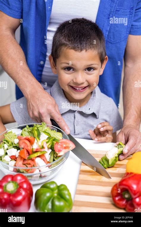 Boy chopping vegetables in the kitchen Stock Photo - Alamy