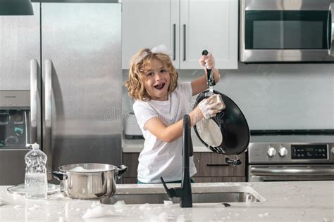 Child Washing the Dishes in the Kitchen Sink. Stock Photo - Image of ...