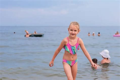 Little Girl Years Old Blond Hair Lies Beach Swimsuit Sea Stock Photo by ...