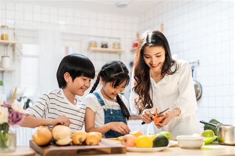 Lovely cute Asian family making food in kitchen at home. Portrait of ...