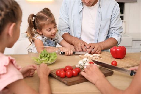 Happy Family Cooking Together at Table in Modern Kitchen Stock Photo ...