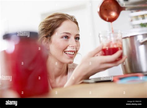 Filling jam into jars Stock Photo - Alamy