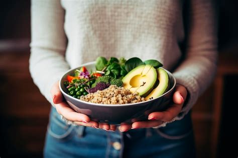 Premium Photo | A person holding a bowl of fresh avocado salad with ...