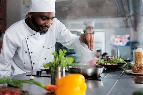 Premium Photo | Skilled gastronomy expert garnishing gourmet dish with ...