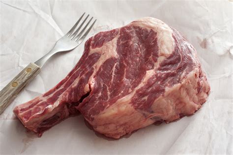 Thick juicy fatty uncooked rib eye beef steak - Free Stock Image