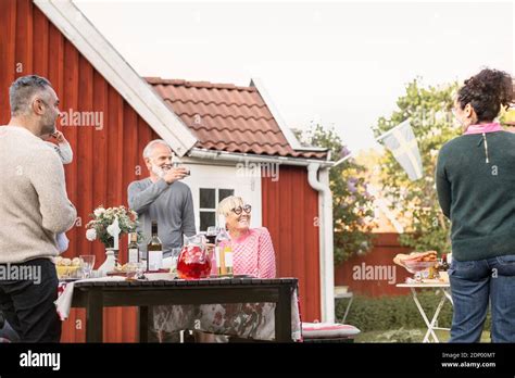 Family having meal in garden Stock Photo - Alamy