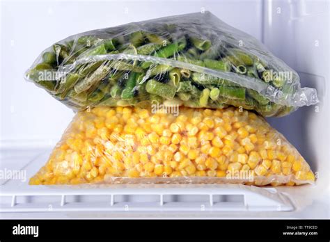 Frozen vegetables in bags in freezer close up Stock Photo - Alamy