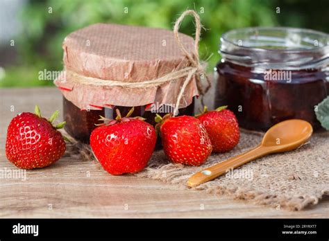 Traditional homemade strawberry jam in jars on wooden boards Stock ...