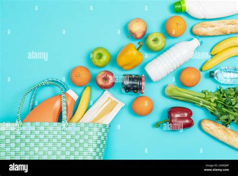 Reusable shopping bag with fresh vegetables and grocery products ...