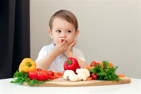 Child Tastes Fresh Vegetable, Healthy Eating, Vegetarianism Stock Photo ...