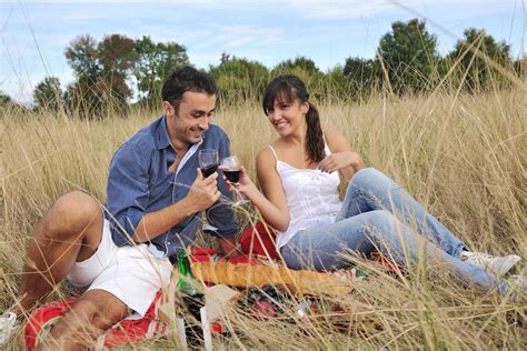 happy couple enjoying countryside picnic in long grass 12642637 Stock ...