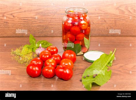 canning tomatoes in glass jars with spices Stock Photo - Alamy