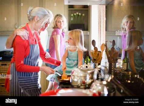 Family cooking together in kitchen Stock Photo - Alamy