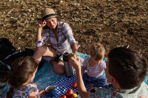 Family Enjoying a Picnic Outdoors on a Sunny Day with Food and Drinks ...