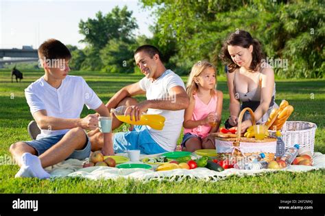 Family enjoying picnic Stock Photo - Alamy
