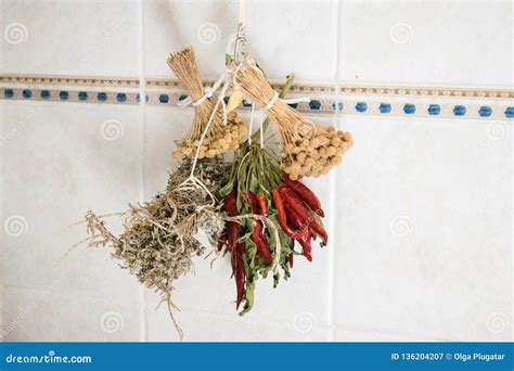 Dried Herb Bundles and Red Peppers Hanging on the Wall Stock Image ...