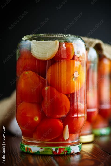 Home preservation. Canned in a glass jar ripe tomatoes. Stock Photo ...