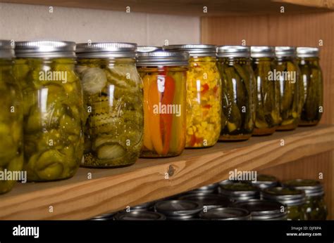 Canned goods on wooden storage shelves in pantry Stock Photo - Alamy